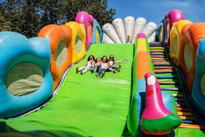 Gorgeous girls having fun on a slide on a sunny day