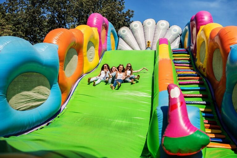 Gorgeous girls having fun on a slide on a sunny day