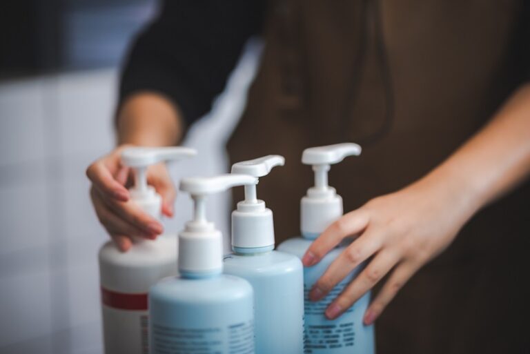 hairdresser presenting fashion treatment cosmetic shampoo to client person in salon