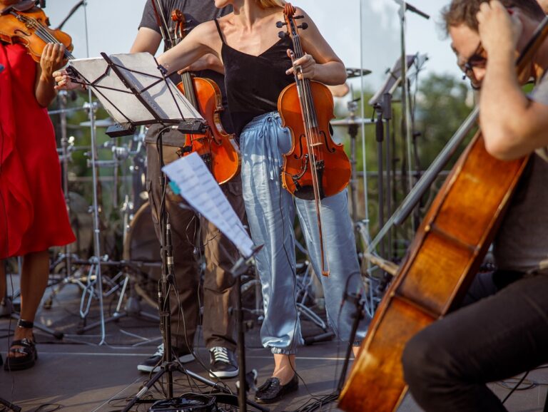 Female violinist having orchestral rehearsal on the street