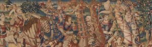 Detailed medieval tapestry of a crowded procession with knights on horseback, soldiers, and townsfolk in bright, patterned clothing.
